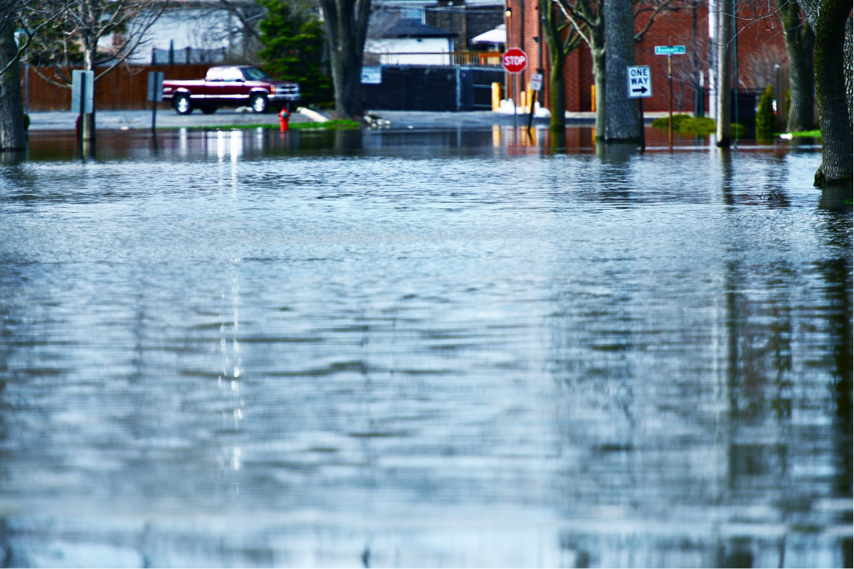 Flooded suburban street showing how rising water can impact homes, reinforcing the importance of home building inspections Brisbane-wide.