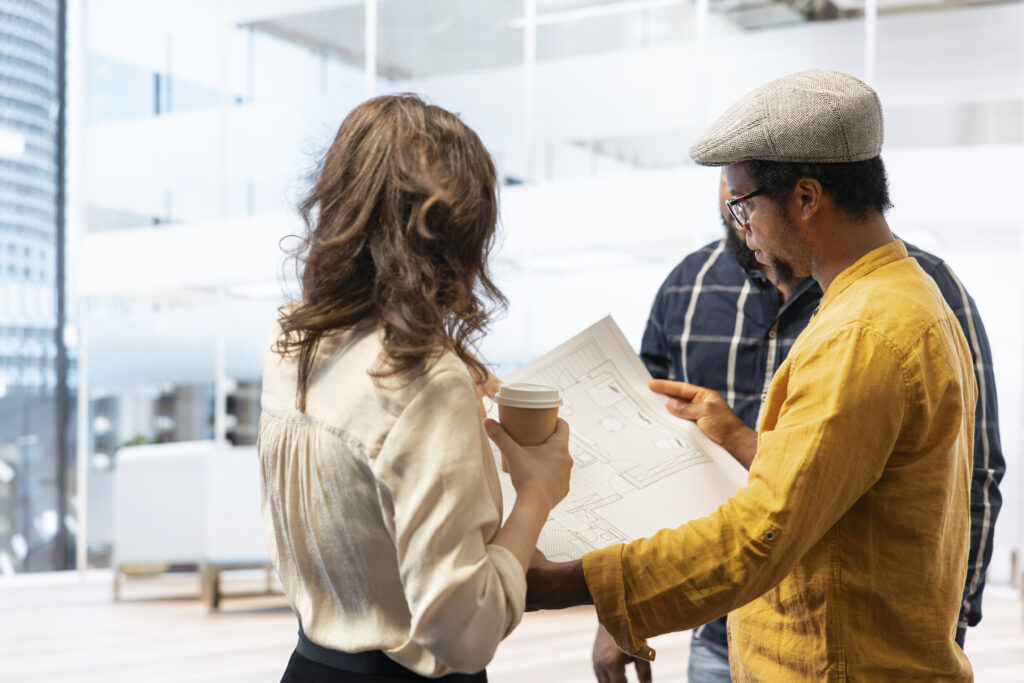 Buyers reviewing plans and inclusions for an off-the-plan apartment purchase.